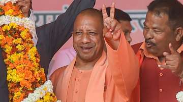 UP Chief Minister Yogi Adityanath flashes victory sign at an election event in Gorakhpur.
