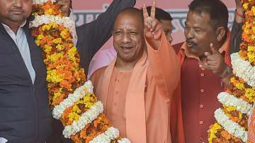 Uttar Pradesh Chief Minister Yogi Adityanath flashes a victory sign during a public meeting in Gorakhpur.