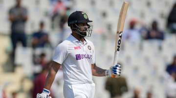 India's Hanuma Vihari raises his bat after scoring fifty runs during the first test