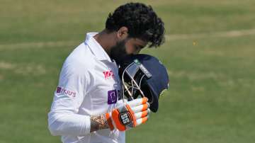 India's Ravindra Jadeja kisses his helmet after scoring a century during the second day of the first