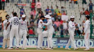 Indian players greet each other after they won the first test match against Sri Lanka by an innings 