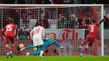 Bayern's Robert Lewandowski (far right) scores the opening goal with a penalty against Salzburg's go