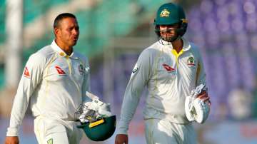 Australia's Usman Khawaja, left, and Nathan Lyon walk back to pavilion on the end of 1st day of seco