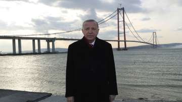 Turkey's President Recep Tayyip Erdogan poses for photos in front of the 1915 Canakkale Bridge, in Çanakkale, western Turkey