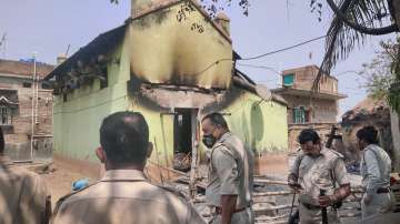 Police personnel near the houses that were set on fire by some miscreants allegedly for avenging the killing of TMC leader Bhadu Sheikh, at Rampurhat in Birbhum district, Tuesday, March 22, 2022. 
