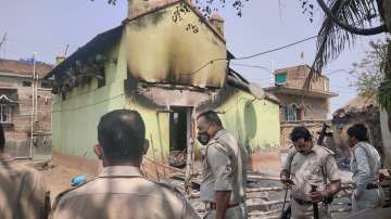 Police personnel near the houses that were set on fire by some miscreants allegedly for avenging the killing of TMC leader Bhadu Sheikh, at Rampurhat in Birbhum district.