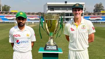 Pakistan skipper Babar Azam and Australian captain Pat Cummins pose with Benaud-Qadir Trophy 