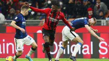 AC Milan's Rafael Leao is challenged by Nicolo Inter's Barella and Milan Skriniar during the Coppa I