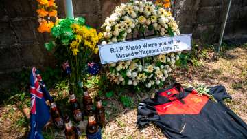 Wreath, flowers and beers are left at the sign for Samujana Villas where Shane Warne died on Saturda
