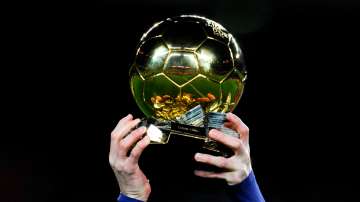 Lionel Messi of FC Barcelona holds up the FIFA Ballon d'Or trophy prior to the La Liga match between