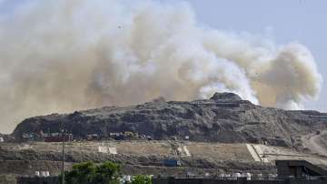 Flames and smoke rise from a fire at Ghazipur Landfill, in New Delhi, Monday, March 28, 2022.