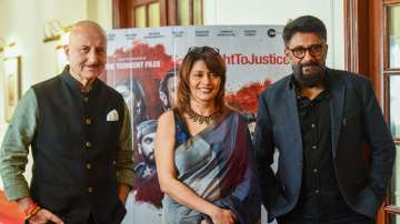 Bollywood actors Anupam Kher and Pallavi Joshi with Film Director Vivek Agnihotri pose for photographs during Kashmir Files press conference at a hotel in New Delhi