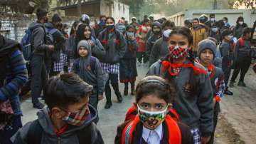 Students arrive at a Kendriya Vidyalaya which resumed all classes following ease in COVID-19 restrictions, in Moradabad, Thursday, Feb 17, 2022.