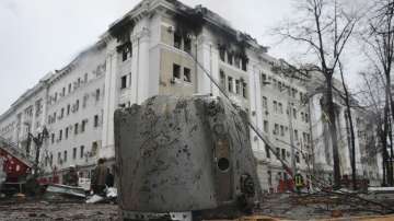 A rocket fragment lies on the ground next to a building of the Ukrainian Security Service (SBU) after a rocket attack in Kharkiv, Ukraine's second-largest city, Ukraine, Wednesday, March 2, 2022.