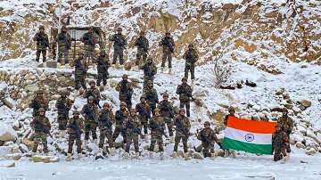 Indian Army soldiers pose for a photograph with the national flag on the occasion of New Year 2022, at the Galwan Valley in Ladakh, Tuesday, Jan. 4, 2022. 