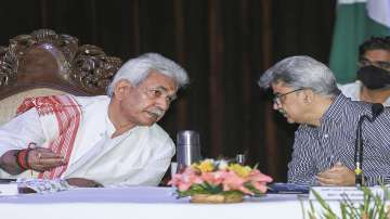 Jammu and Kashmir Lt. Governor Manoj Sinha talks with Additional Chief Secretary Atal Dulloo during a press conference, at Convention Centre, in Jammu