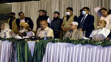 Pakistan's opposition leaders Shahbaz Sharif, seated center, Asif Ali Zardari, second right, and lawmakers from the government's coalition party, give a press conference about the country's latest political situation, in Islamabad, Pakistan, Monday, March 28, 2022.