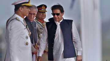 Pakistan's Prime Minister Imran Khan (Right) arrives to attend a military parade.