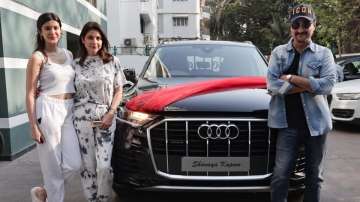 Shanaya Kapoor, her parents Maheep Kapoor and Sanjay Kapoor pose with her new car Audi Q7