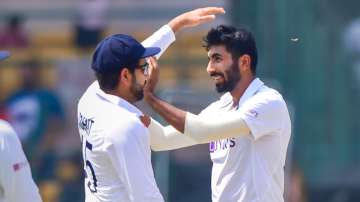 Jasprit Bumrah celebrates with Indian skipper Rohit Sharma after taking a wicket during India vs Sri