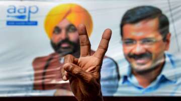 An Aam Aadmi Party (AAP) supporter flashes the victory sign, to celebrate the partys victory during the counting day of Punjab Assembly elections, in Amritsar.