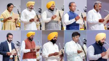 AAP MLAs being administered oath during the oath-taking ceremony of Punjab Cabinet ministers, in Chandigarh, Saturday, March 19, 2022.