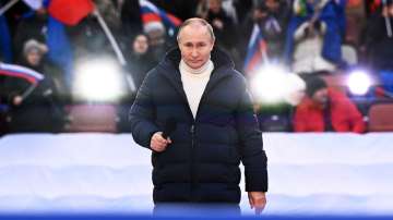 Russian President Vladimir Putin delivers his speech at a concert marking the eighth anniversary of the referendum on the state status of Crimea and Sevastopol and its reunification with Russia, in Moscow, Russia on Friday, March 18, 2022.