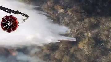 IAF helicopters are used to spray water over a forest fire in the Sariska Tiger Reserve, in Alwar district.