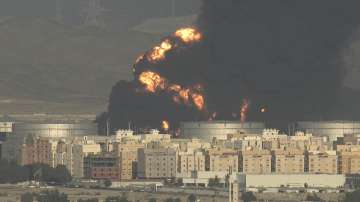 A cloud of smoke rises from a burning oil depot in Jiddah, Saudi Arabia, Friday, March 25, 2022. 