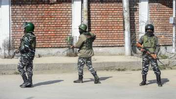 Armed security personnel stand at guard, in Srinagar, Saturday, Feb. 19, 2022. 