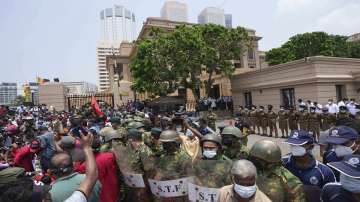 Members of the Socialist Youth Union shout slogans outside the president's office during a protest against the worst economic crisis in memory in Colombo, Sri Lanka, Friday, March 18, 2022.