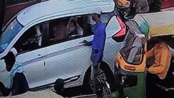 BJP leader Vijay Goel in his car as man snatches his mobile phone 