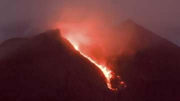 Lava flows down from the crater of Mount Merapi seen from Cangkringan village in Sleman, Yogyakarta