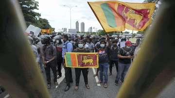 Colombo: Sri Lankans protest demanding president Gotabaya Rajapaksa resign, behind a police barricade on a street leading to the parliament?