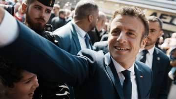 French President and centrist candidate Emmanuel Macron shakes hands with well-wishers as he heads to the polling station in Le Touquet