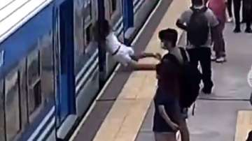 Woman falls under moving train at 