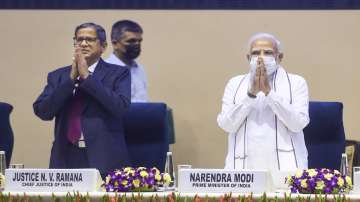 Prime Minister Narendra Modi gestures during a joint conference of CMs of States & Chief Justices of High Courts at Vigyan Bhawan in New Delhi. Chief Justice of India N. V. Ramana is also seen. 