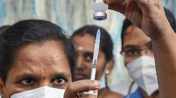 A healthcare worker prepares a dose of Covid-19 vaccine before administering it to a student, at a school premises, in Chennai.
