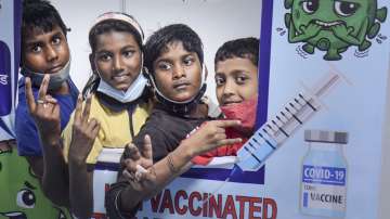 Students pose for photos after receiving a dose of Covid-19 vaccine at a vaccination centre.