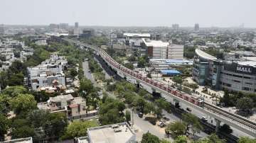 An aerial view of a train running on its tracks after Delhi Metro services resumed.