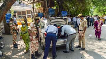 Delhi Police personnel check a vehicle at the Rohini Court in New Delhi, Saturday, Sept 25, 2021.