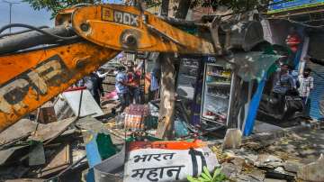 A bulldozer being used to demolish illegal structures during a joint anti-encroachment drive by NDMC, PWD, local bodies and the police, in the violence-hit Jahangirpuri area.