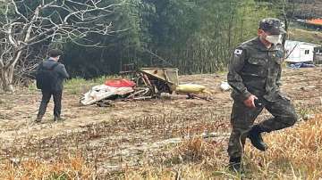 Debris from the South Korean Air force's KT-1 trainer aircraft collision are seen at a field in Sacheon, South Korea.?