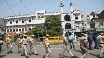 Security personnel stand guard, after clashes broke out between two communities during a Hanuman Jayanti procession on Saturday at Jahangirpuri in New Delhi