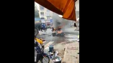 The people standing nearby try to help one of the men by pouring water on him.?