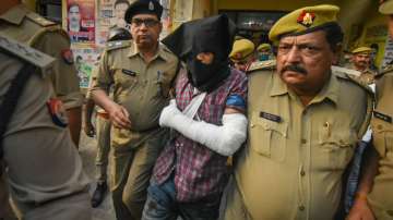 Ahmed Murtaza Abbasi, accused of attacking policemen outside the Gorakhnath temple, being presented in a court by police, in Gorakhpur, Monday, April 4, 2022.