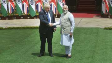 PM Narendra Modi and British PM Boris Johnson shake hands prior to their meeting at Hyderabad House, in New Delhi, Friday, April 22, 2022.