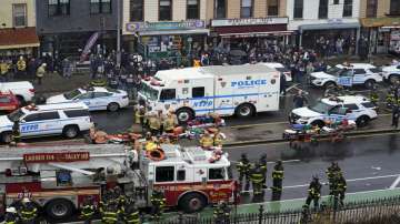 Emergency personnel gather at the entrance to a subway stop in the Brooklyn borough of New York, Tuesday, April 12, 2022. Multiple people were shot and injured Tuesday at a subway station in New York City during a morning rush hour attack.