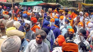 Patiala: Security personnel maintain law and order after a clash broke out between two groups, near Kali Mata Mandir in Patiala, Friday, April 29, 2022.