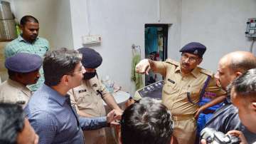 District Magistrate Sanjay Khatri with police during investigation after five members of a family including a couple and their three children were found dead inside their rented accommodation at Khagalpur village in Prayagraj district